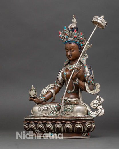 Left side view of Dukar Sitatapatra statue, copper craftsmanship with turquoise and coral inlays