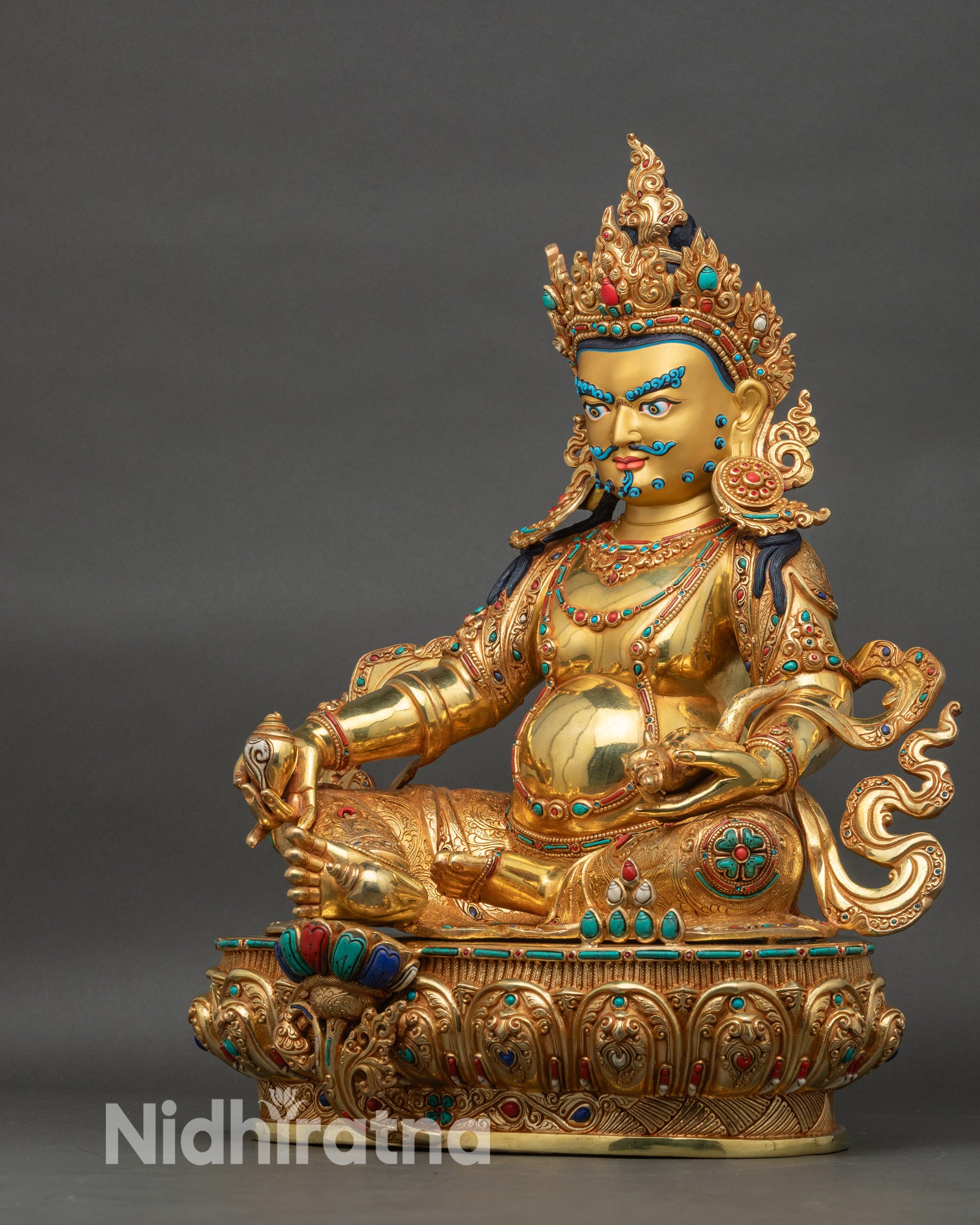 Left side view of Dzambhala statue displaying detailed posture and gilded copper body
