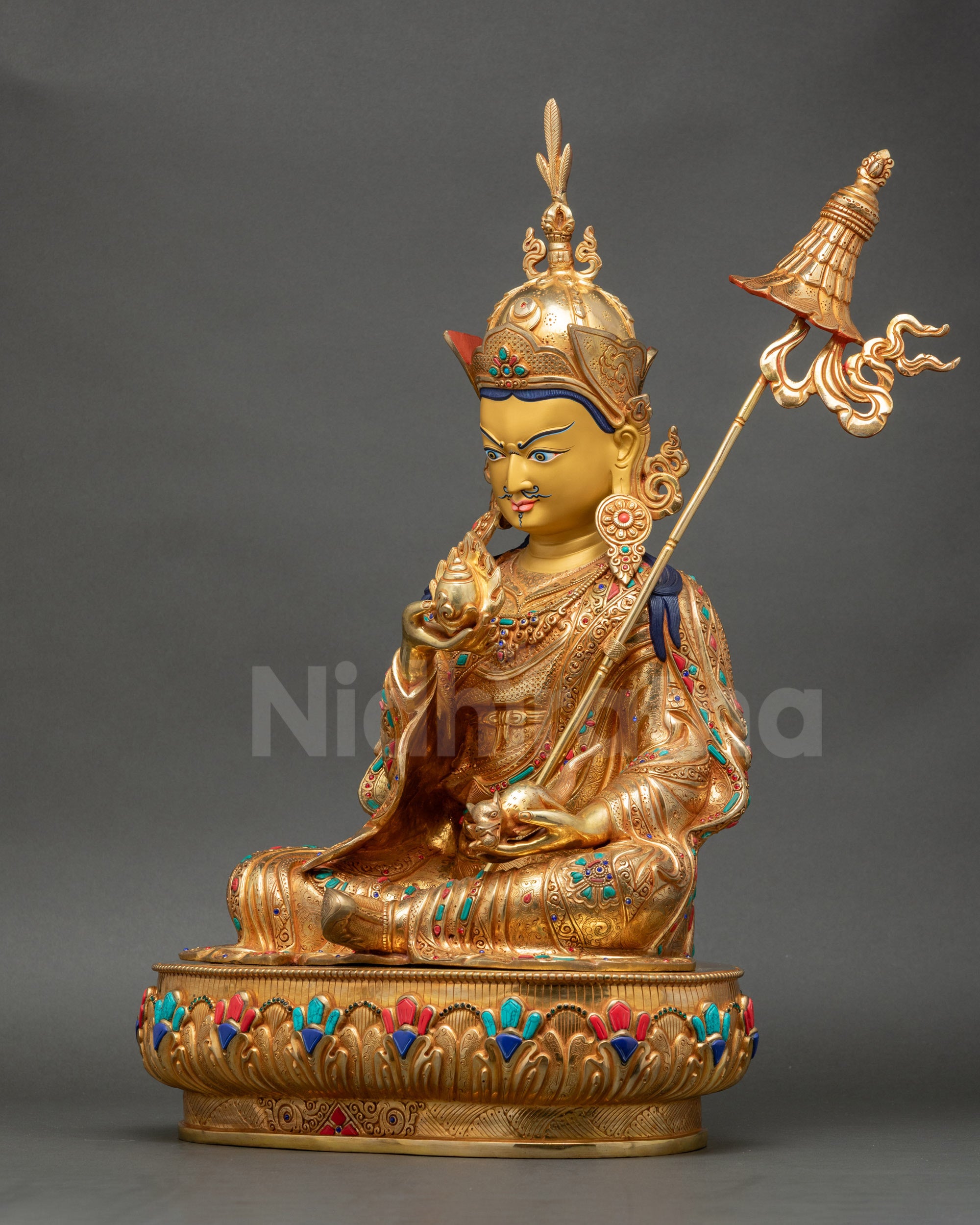 Left side view of Guru Norlha Sculpture showing intricate trident and chintamani details