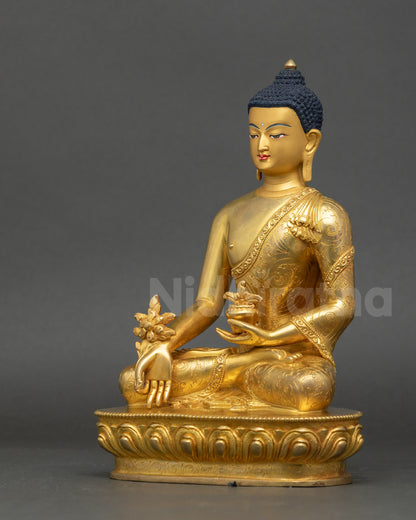 Left side view of Healing Buddha Bhaisajyaguru Statue highlighting gold gilded details
