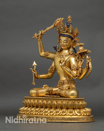Left side view of Maha Manjushri statue with detailed patterns and sacred objects