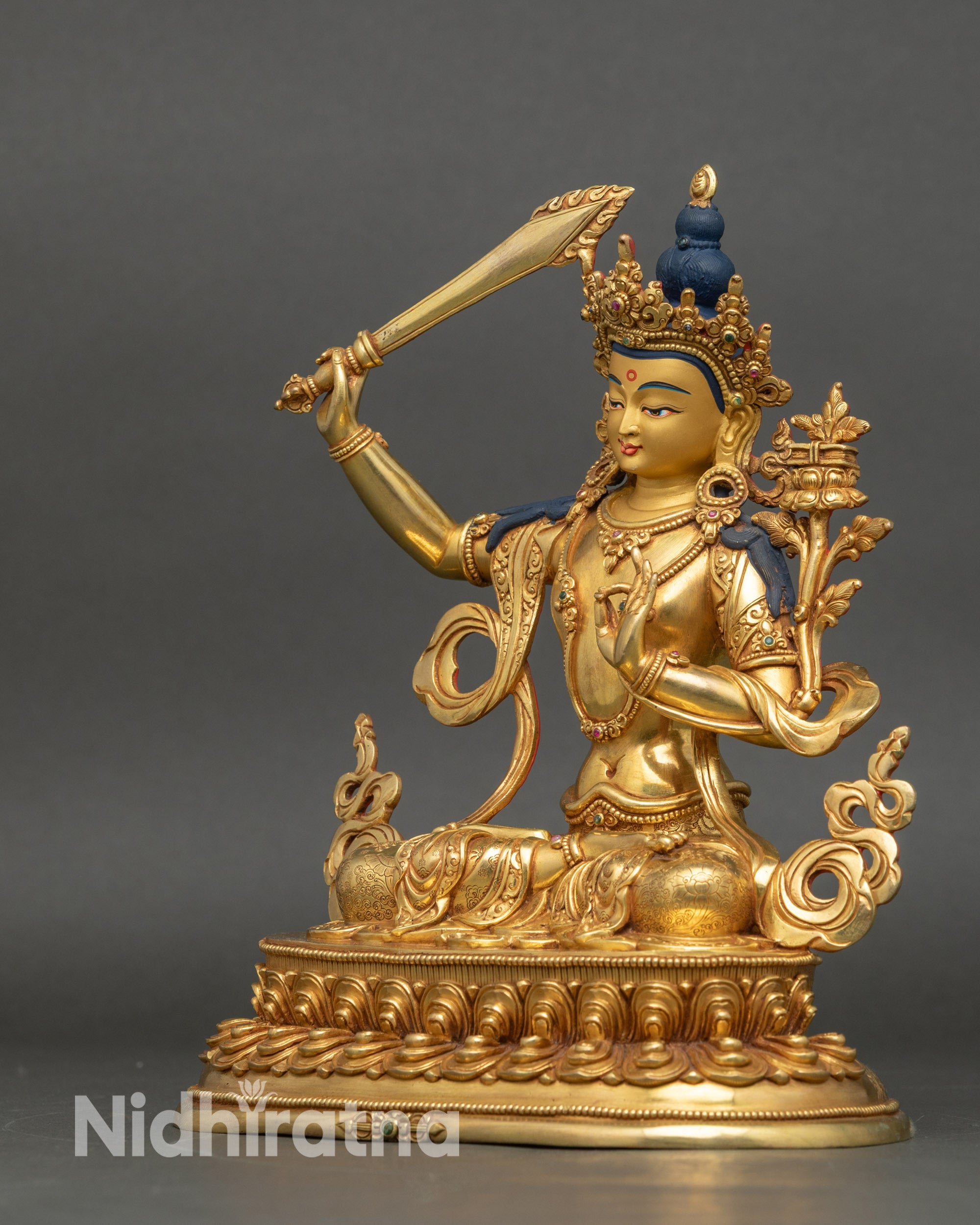 Left side view of Manjushri Sculpture with sword and utpala flower details