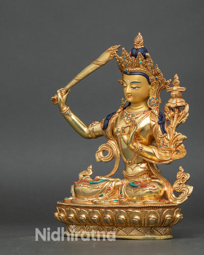 Left side view of Manjushri statue, showcasing detailed patterns and sacred Buddhist symbolism