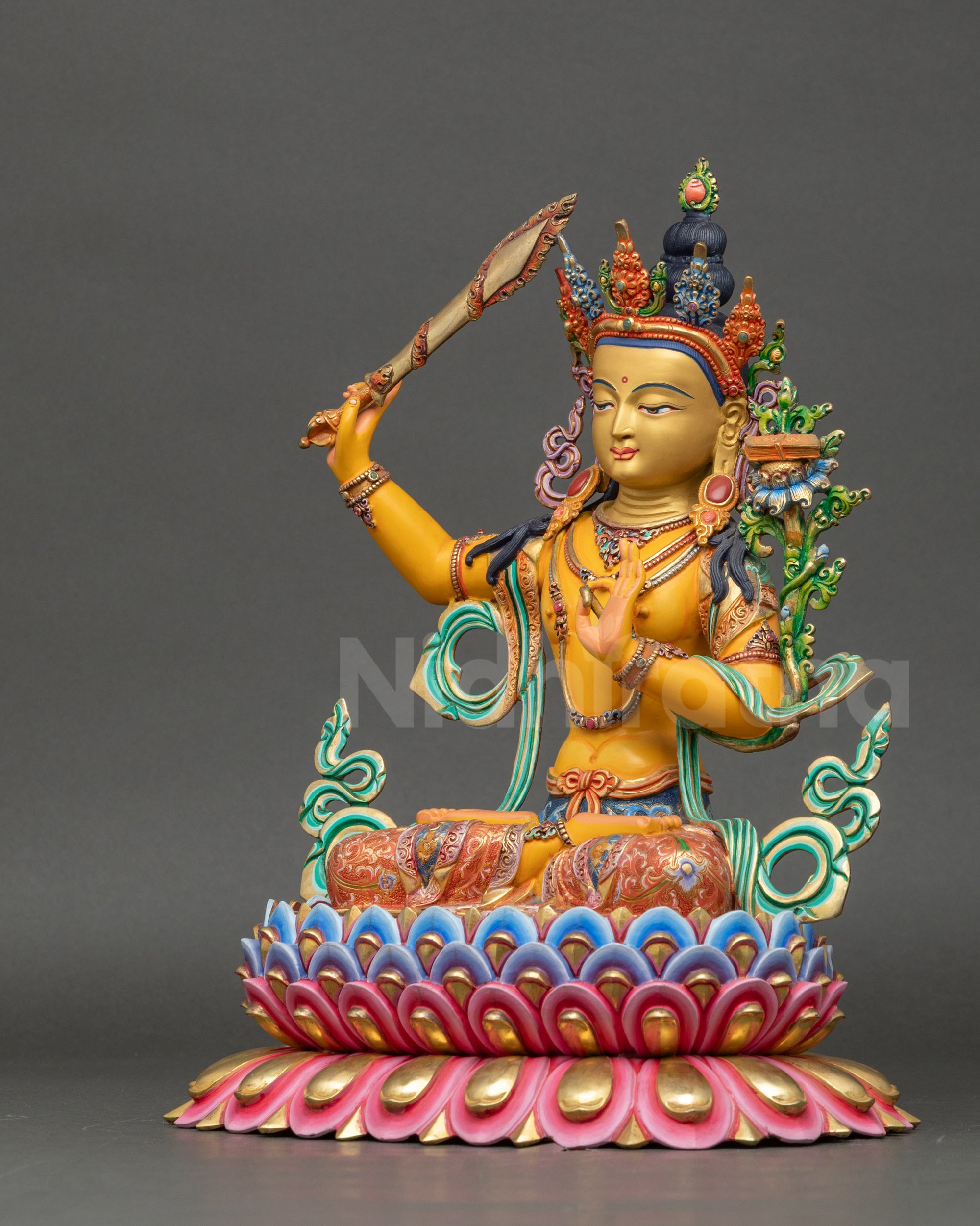 Left side view of Manjushri statue with detailed floral garments and lotus seat