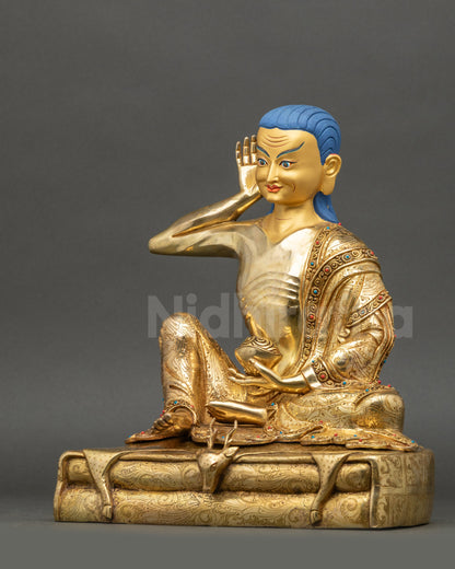 Left side view of Milarepa statue showing flowing carved robes and gilding