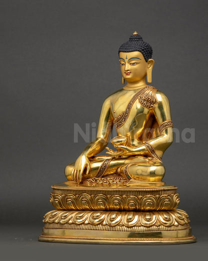 Left side view of Shakyamuni Buddha Statue capturing detailed gold-gilded garments