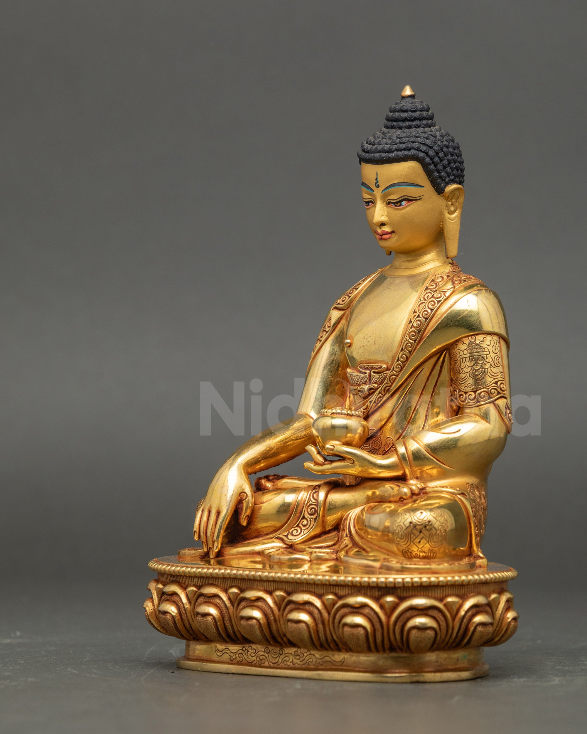 Left side view of Shakyamuni Buddha, copper sculpture with gold detailing