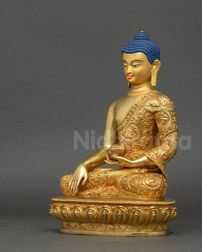 Left side view of Shakyamuni Buddha statue with meditation posture and gilded detail