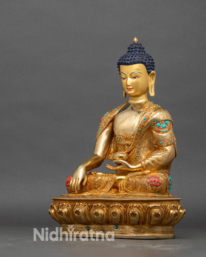 Left side view of Shakyamuni Buddha statue with turquoise coral robe borders and lotus base