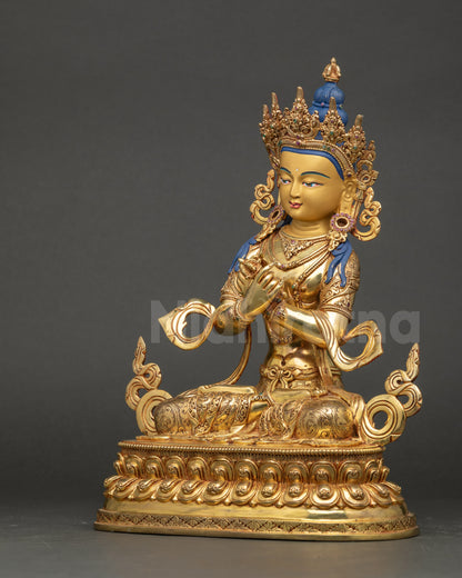 Left side view of Vajradhara Statue showing gold-painted face and detailed robes