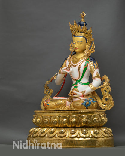 Left side view of Vajrasattva sculpture showing detailed lotus seat and vibrant gold layers
