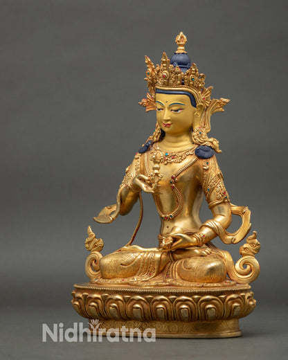 Left side view of Vajrasattva statue with intricate lower garment and jewelry carvings