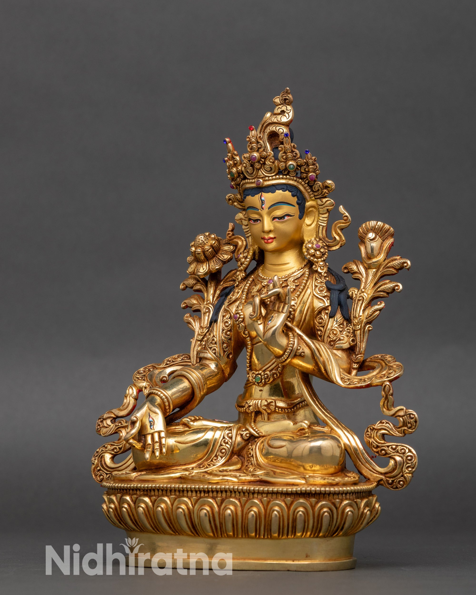 Left side view of White Tara Statue, intricate gold and semi-precious stone details