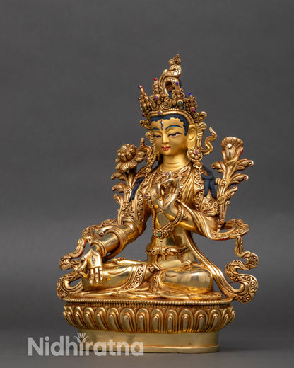 Left side view of White Tara Statue, intricate gold and semi-precious stone details