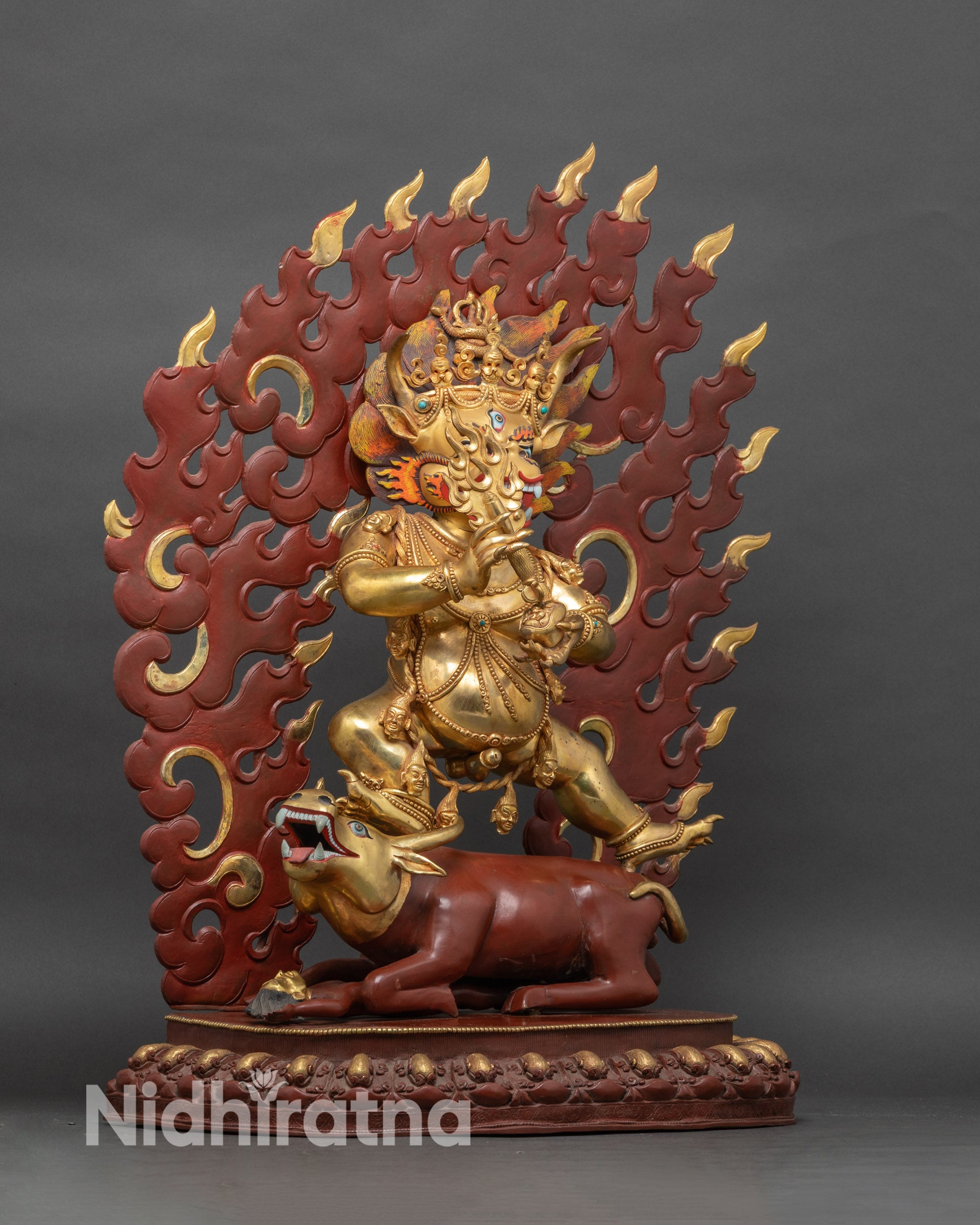 Left side view of Yamantaka statue highlighting ornate arms and lotus seat