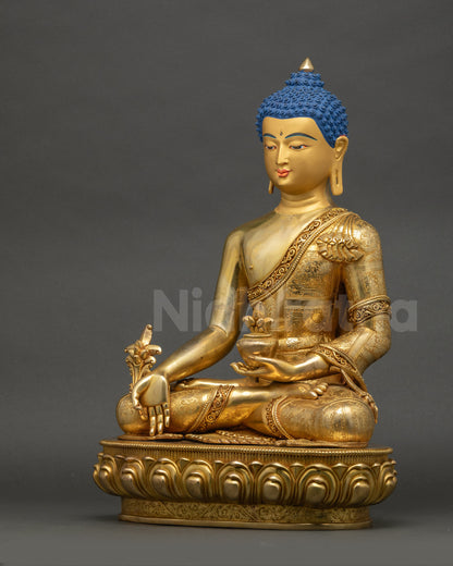 Left side view of gold Medicine Buddha statue showing intricate robe and halo