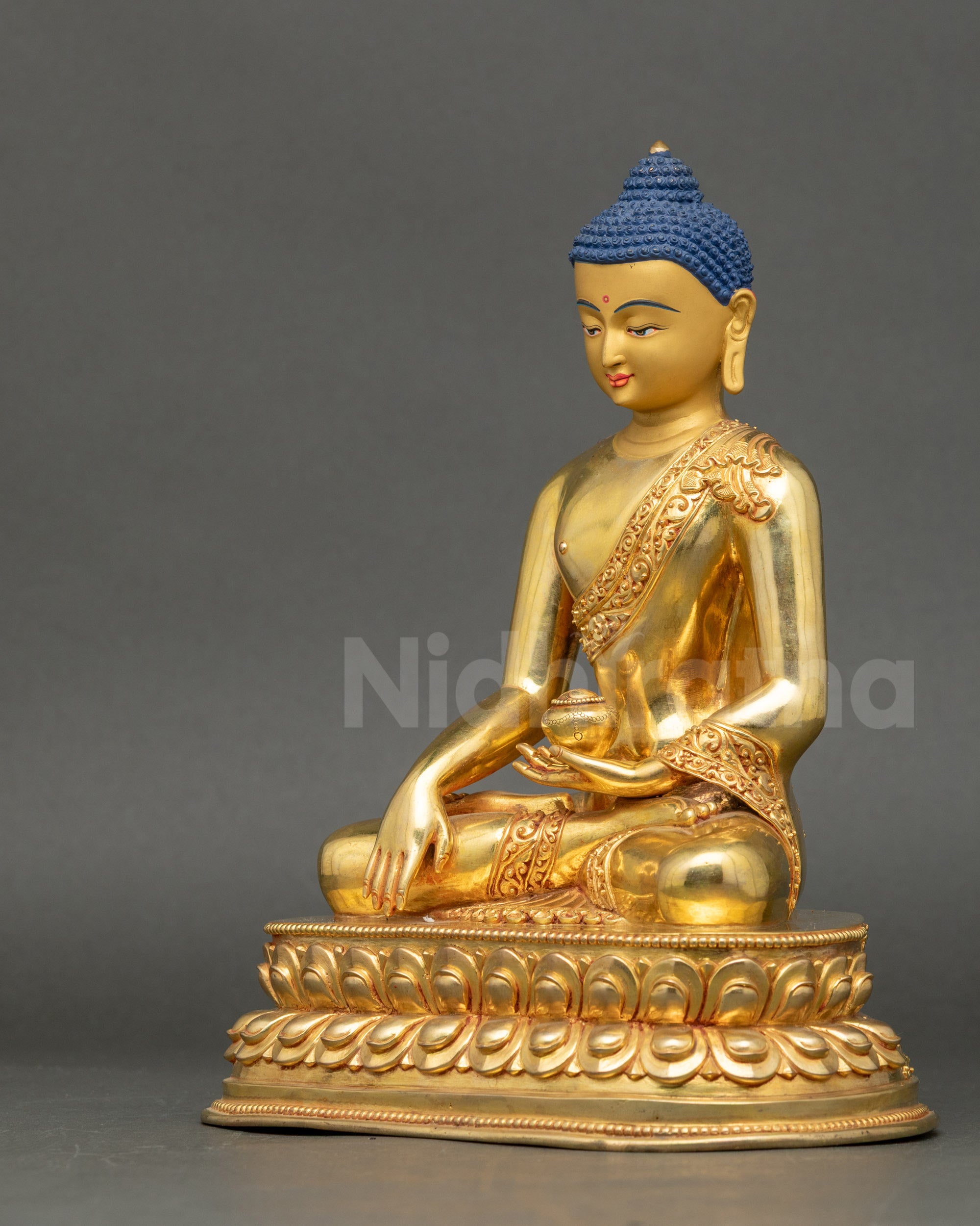 Left side view of handcrafted Shakyamuni Buddha statue with flowing monastic robe
