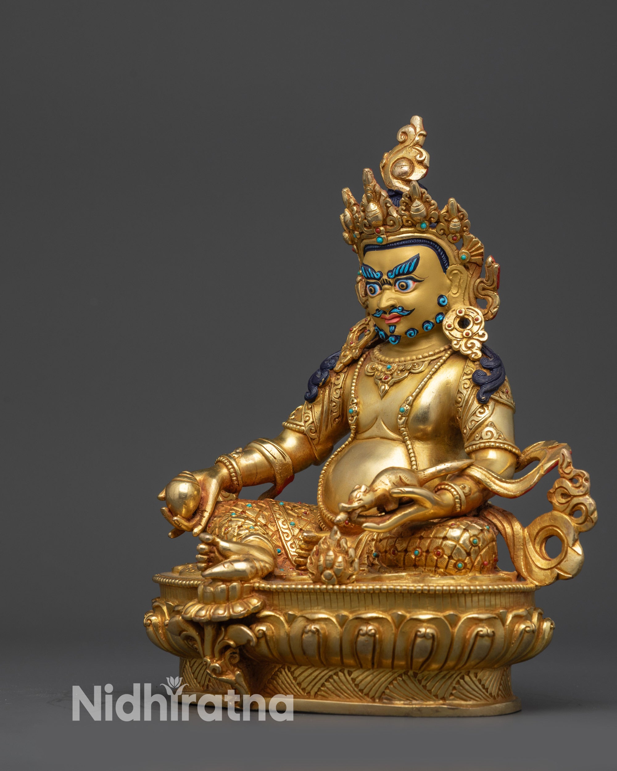 Left side view of the Dzambhala Buddhist wealth god statue on lotus seat.