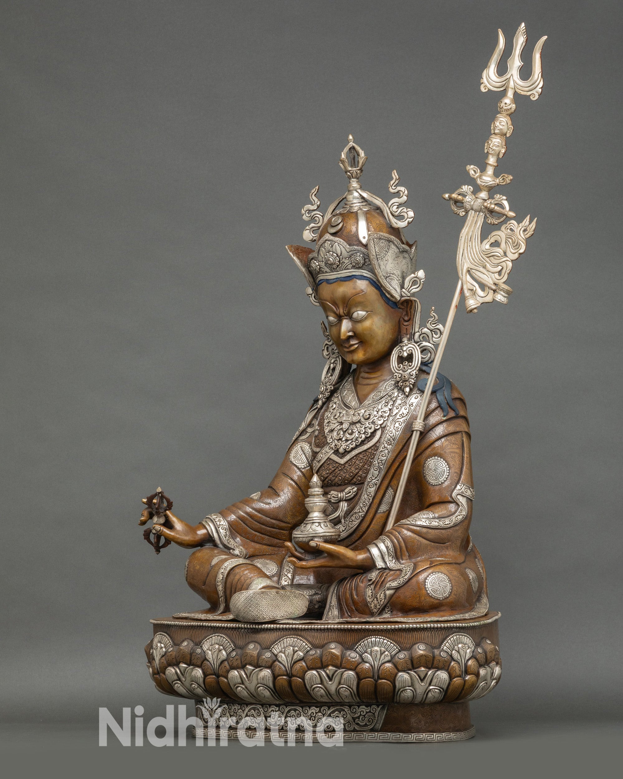 Left view Padmasambhava statue, vajra and skull cup detail, oxidized copper Buddhist sculpture