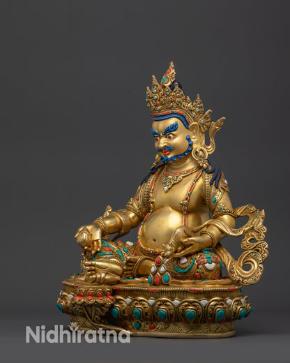 Left view side Dzambhala Statue showing elaborate garments and intricate carved patterns