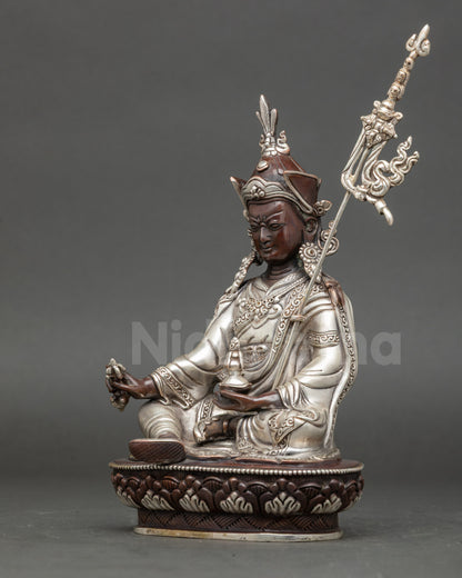 Left view side Guru Padmasambhava oxidized copper statue showing ritual attributes