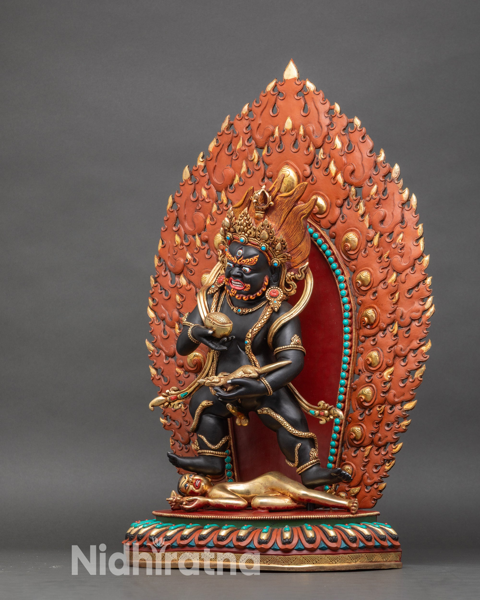 Left view side – Left profile of Black Dzambhala statue showing kapala and jewel-spitting mongoose details