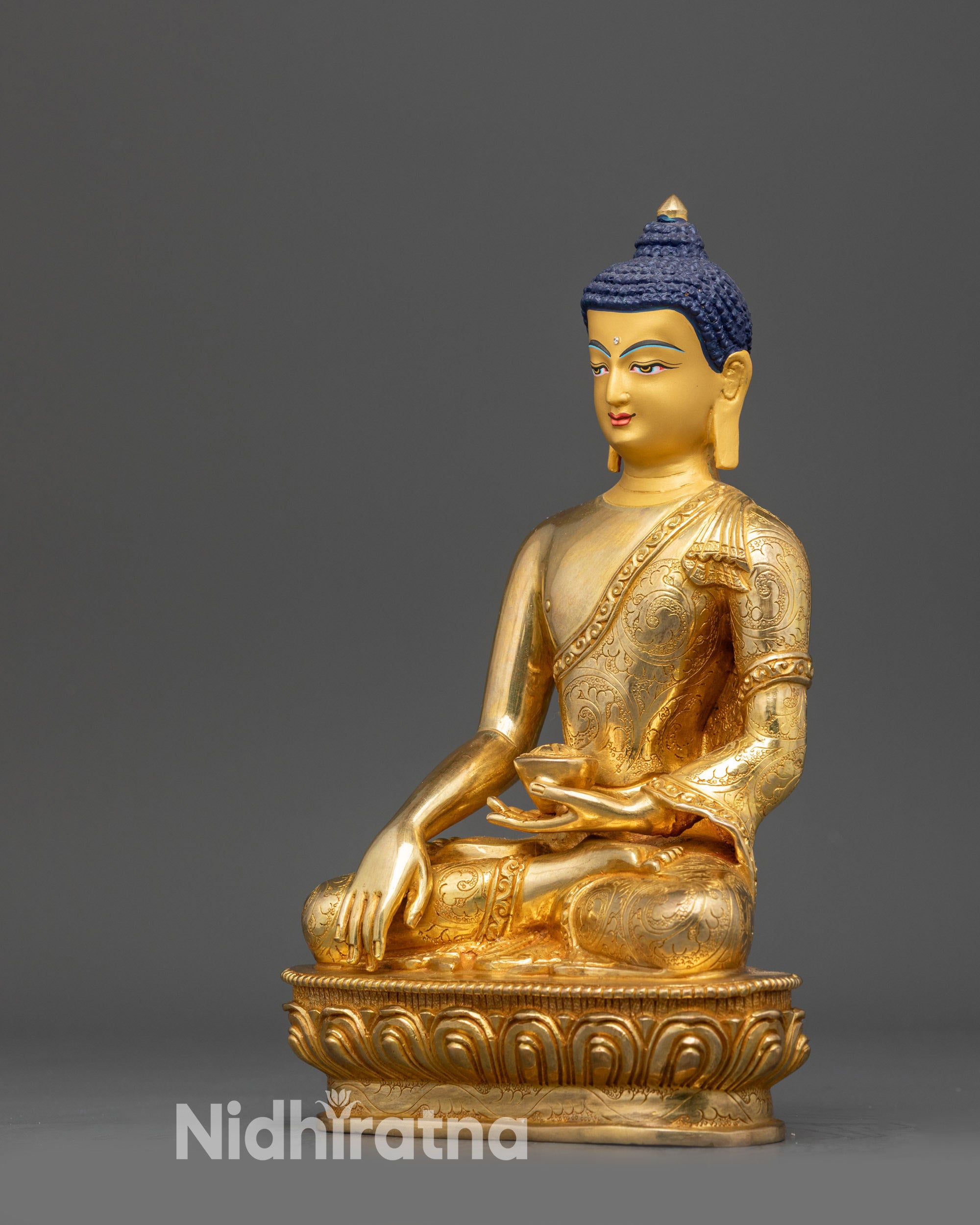 Left view side Shakyamuni Buddha statue showing monk robe patterns and lotus seat