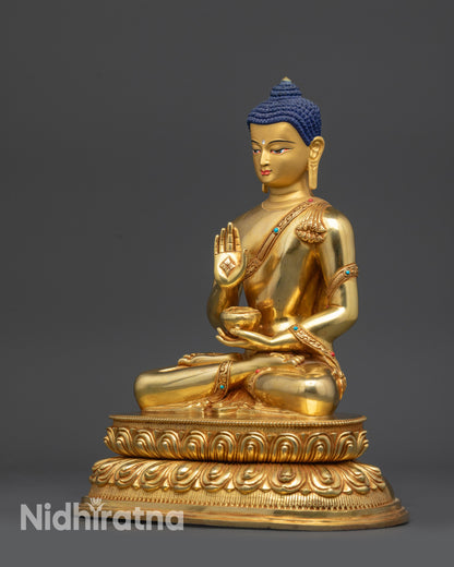 Left view side of Amoghasiddhi Buddha statue holding bowl and detailed robe patterns
