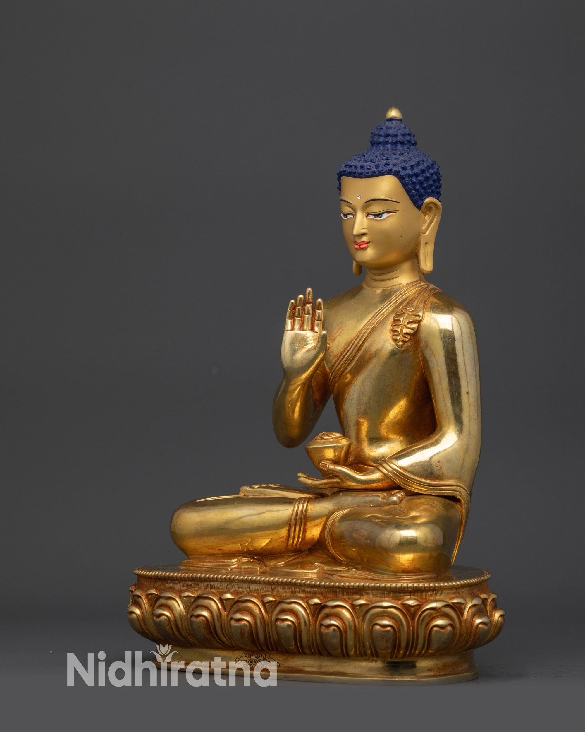 Left view side of Amoghasiddhi Buddha statue showing lotus pedestal and hand mudra
