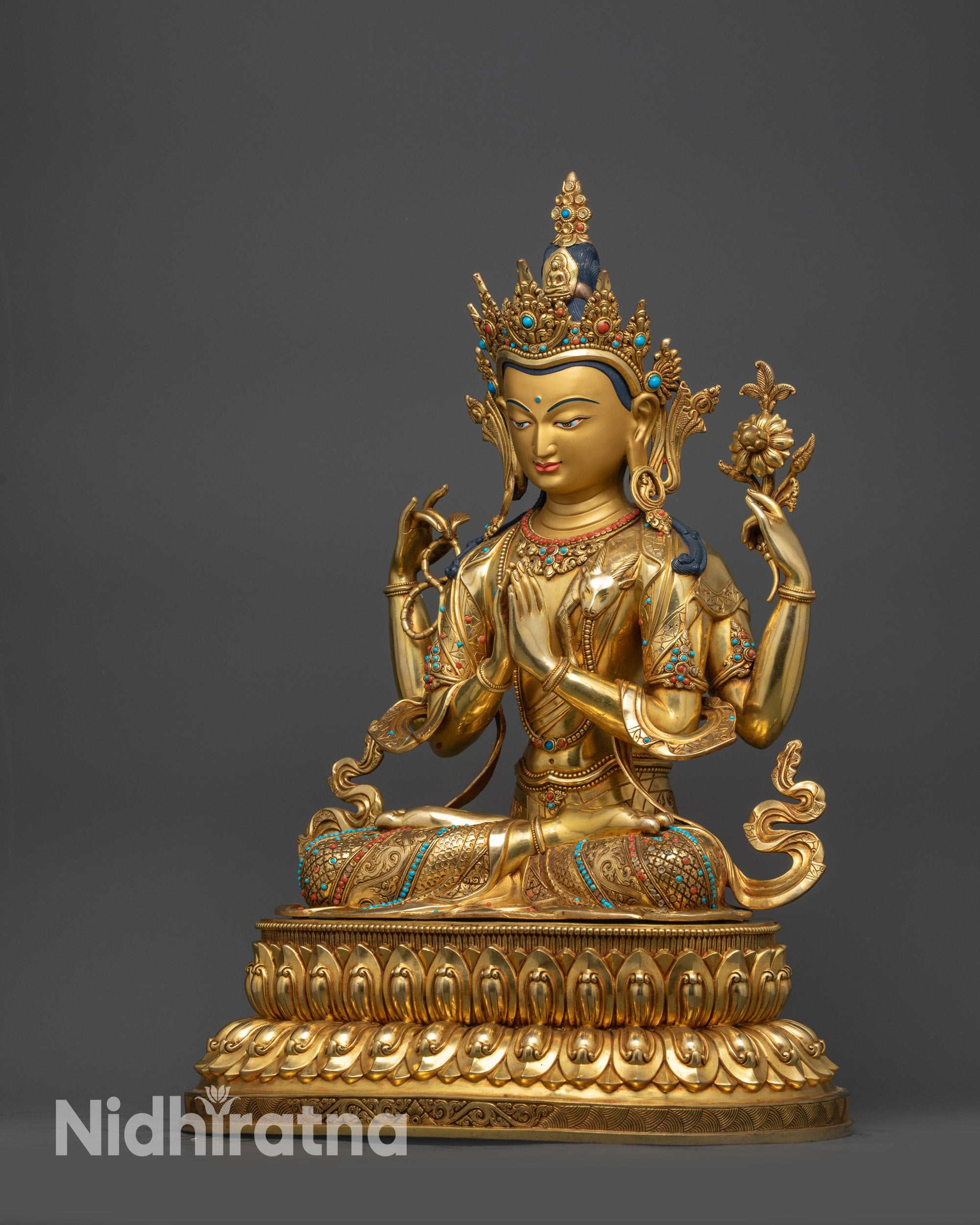 Left view side of Chenrezig holding lotus flower with flowing majestic robes
