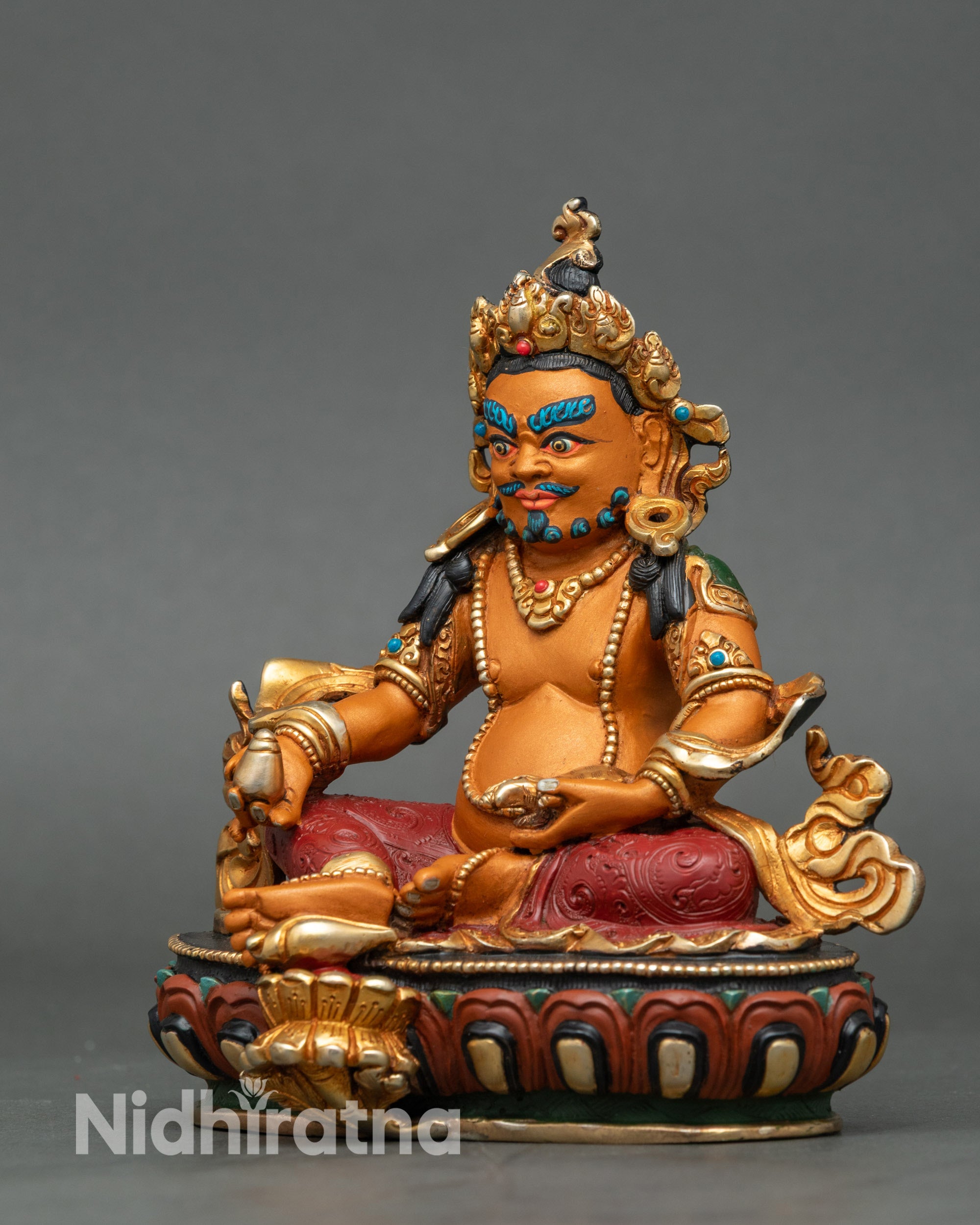 Left view side of Dzambhala Buddha Statue capturing citrion fruit and mongoose symbol
