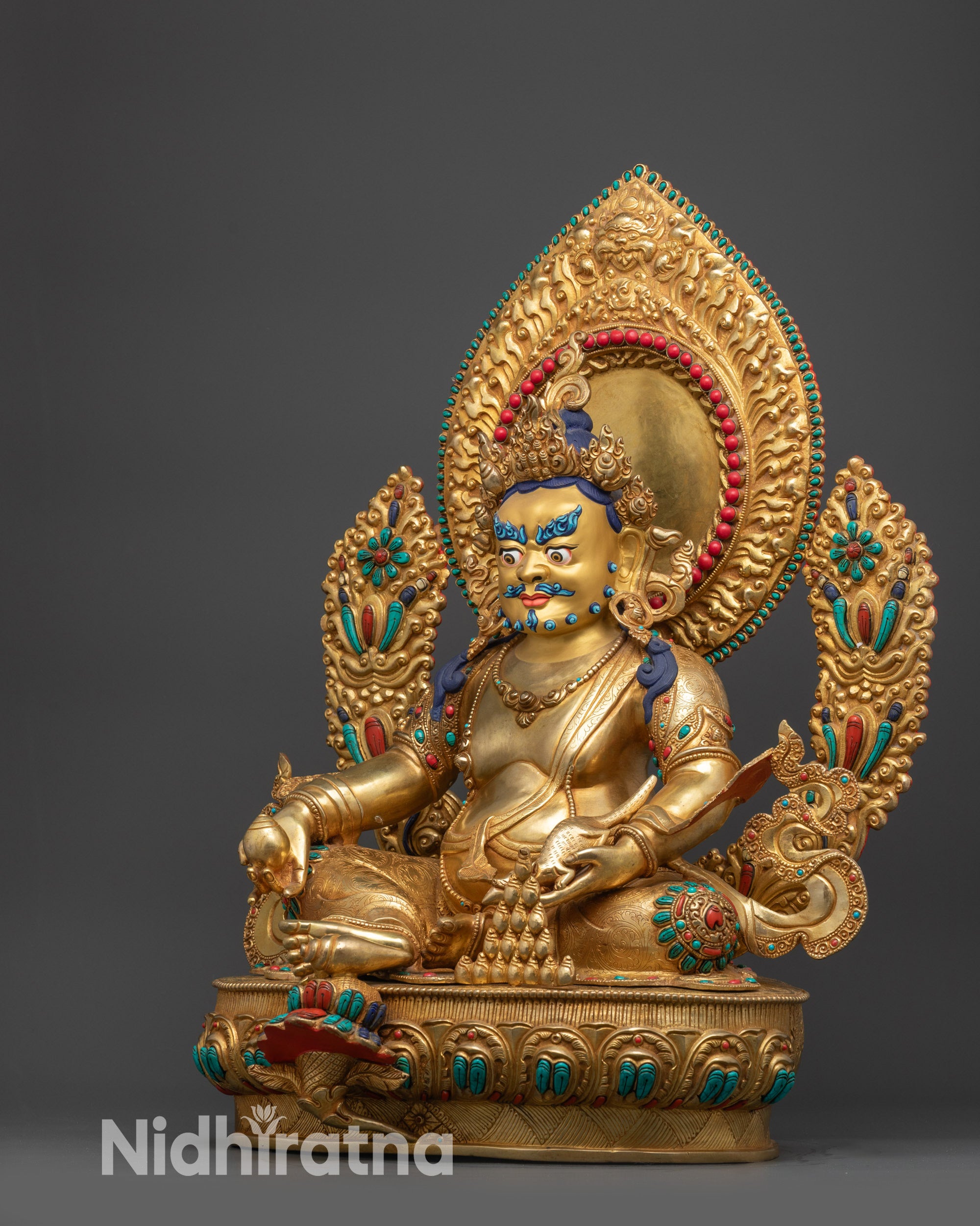 Left view side of Dzambhala Statue displaying intricate robes and semi-precious stones
