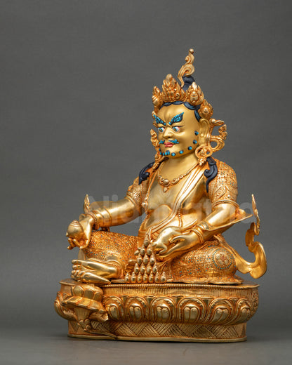 Left view side of Dzambhala Statue showing gold fire-gilded copper details
