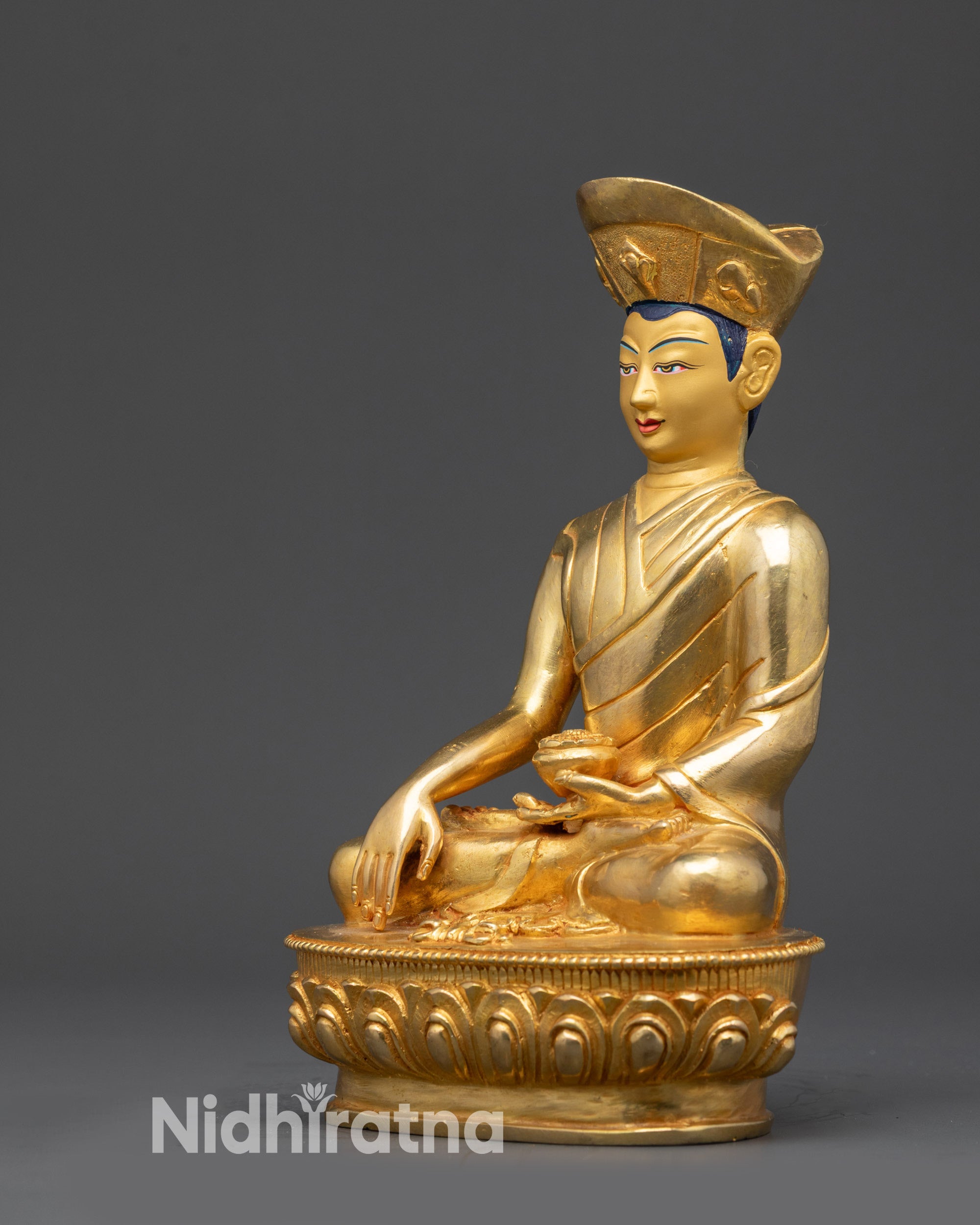 Left view side of Eighth Karmapa Jigten Sumgon statue holding bowl in bhumisparsa mudra
