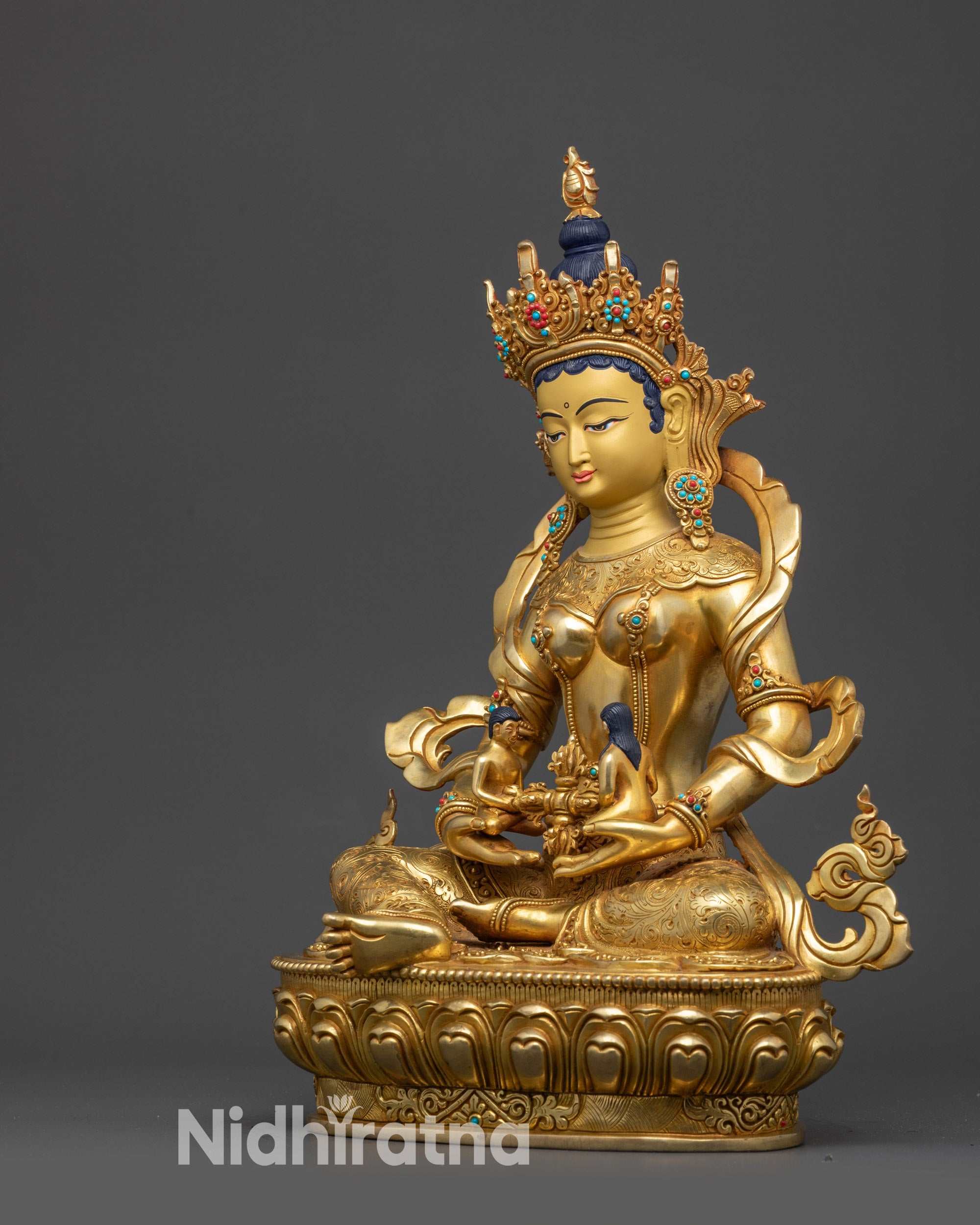 Left view side of Green Tara Statue, intricate jewelry and lotus seat carvings visible

