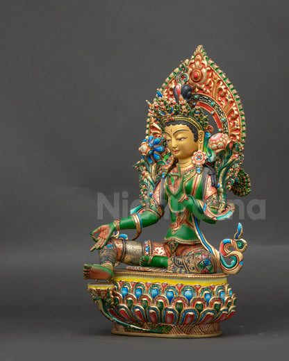 Left view side of Green Tara sculpture highlighting flowing robe and lotus-seated posture
