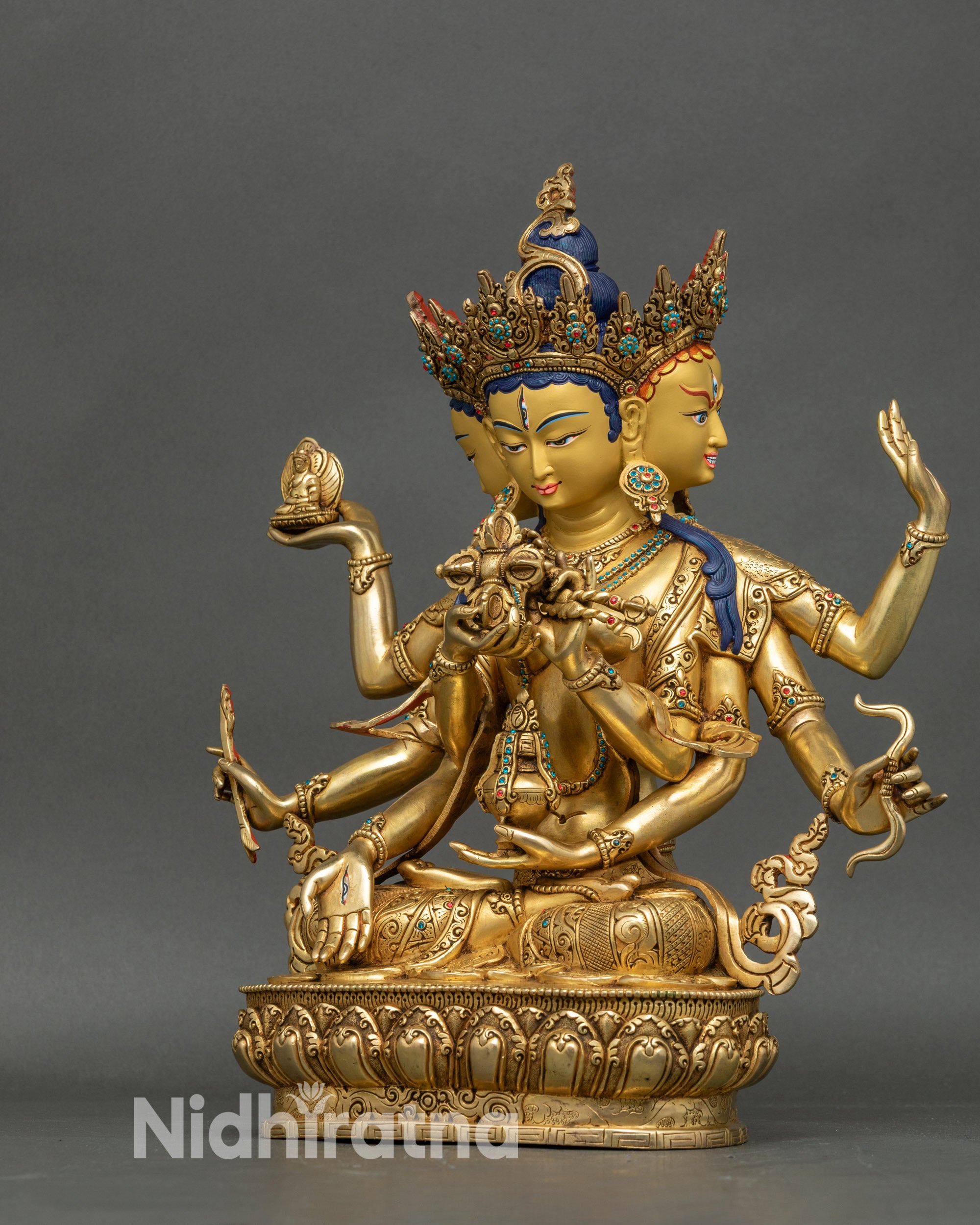 Left view side of Namgyalma statue highlighting arrow, Buddha, and ornate gold carvings