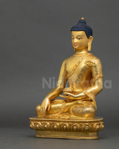 Left view side of Shakyamuni Buddha statue showing lotus seat and intricate robe details
