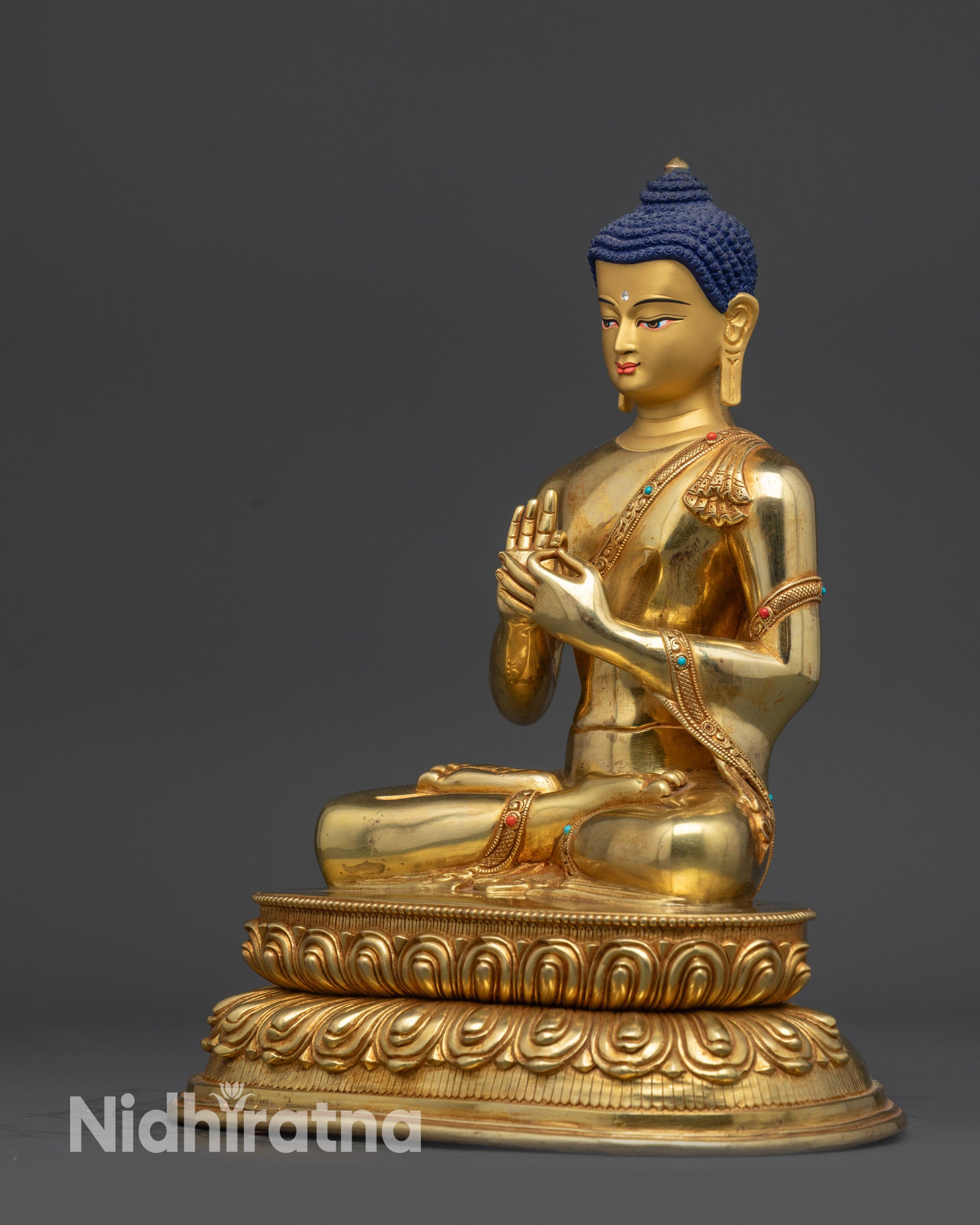 Left view side of Suvarnabhadra Vimala Buddha statue showing dharmachakra mudra hand gesture
