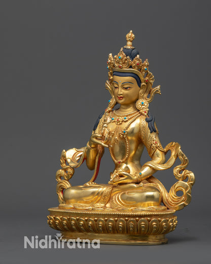 Left view side of Vajrasattva statue with vajra, bell, and flowing robe details
