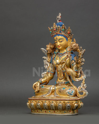 Left view side of White Tara sculpture showing utpala flower and layered ornaments