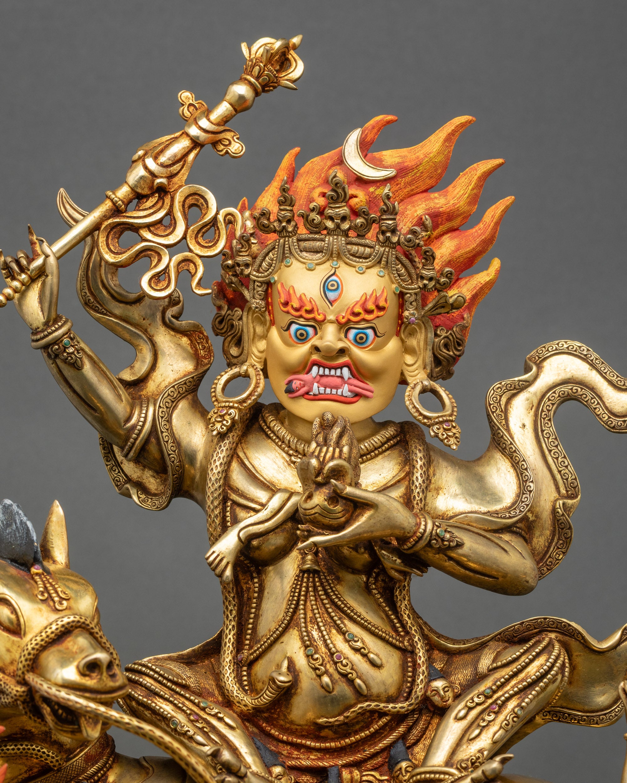 Life-size Palden Lhamo copper statue, gold gilded robes, skull crown, ornate jewelry, flame backdrop