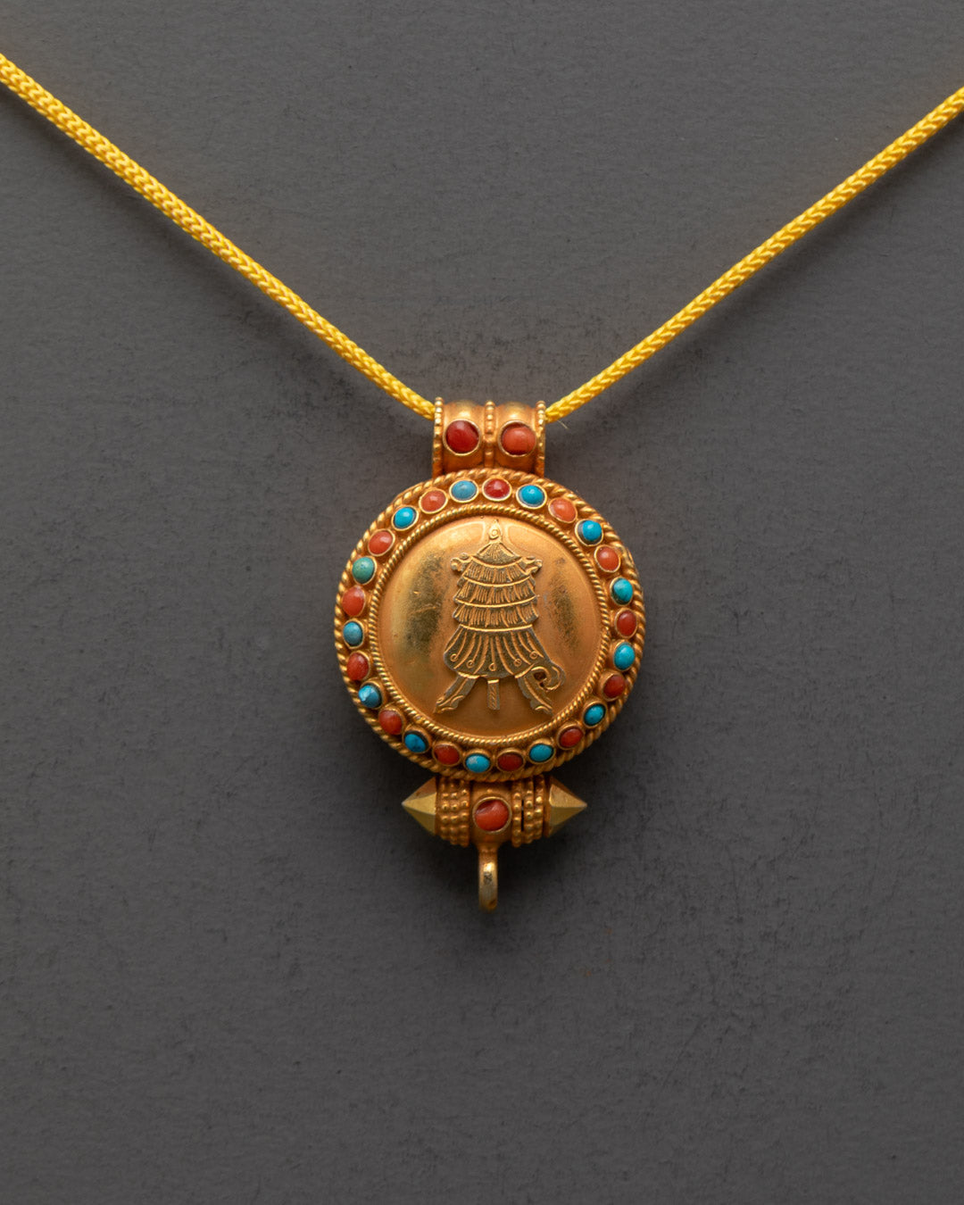Front view of gold-gilded Tibetan Victory Banner Locket with semi-precious stones
