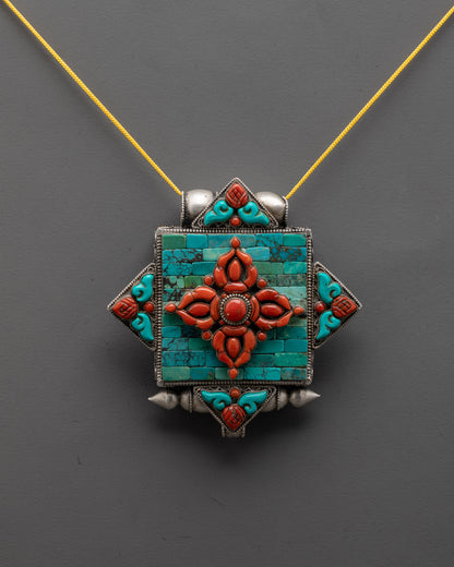 front view of Bishwo Vajra locket with coral vajra and turquoise on silver body