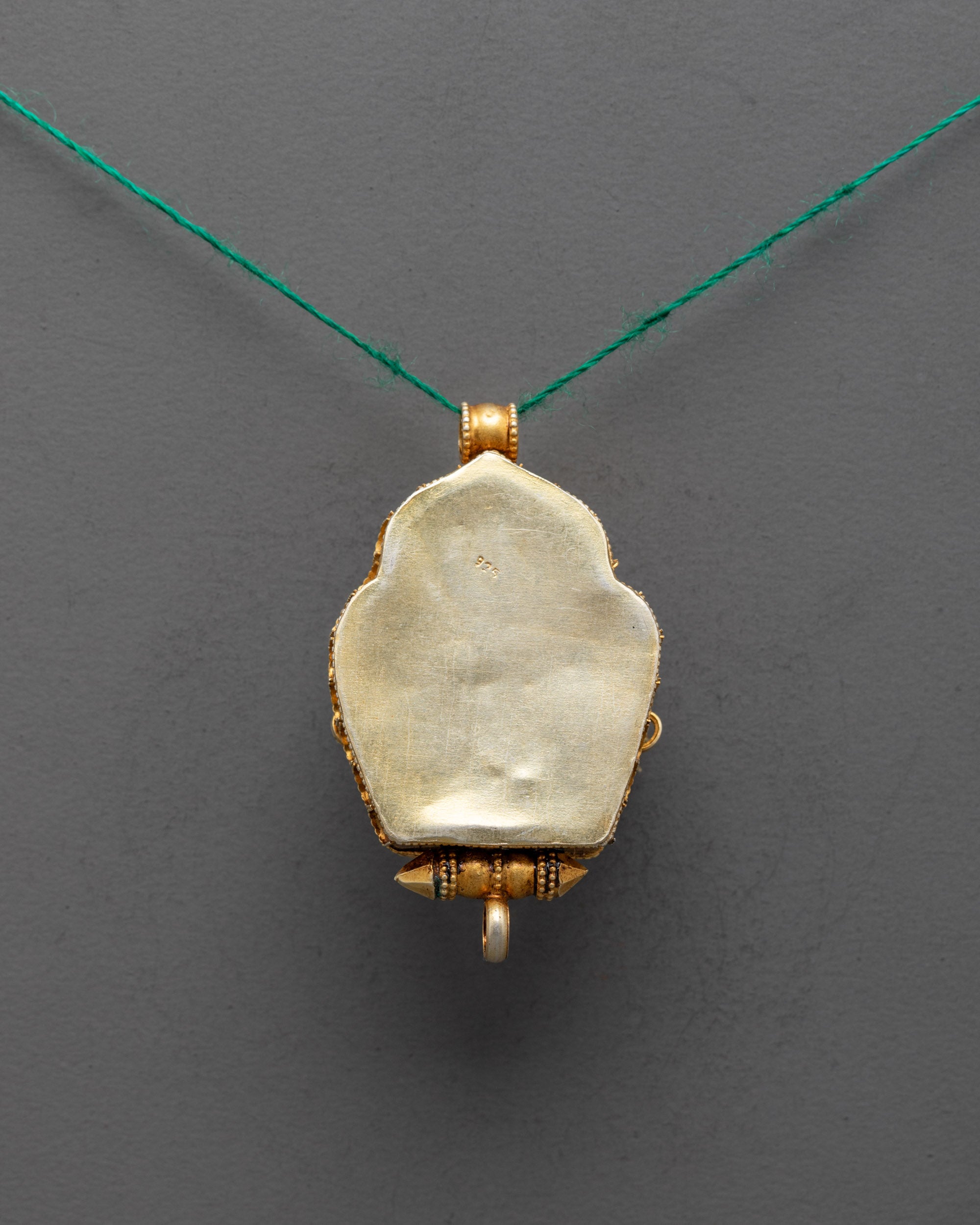 Back view of gold-plated Green Tara Locket showing detailed carved filigree craftsmanship