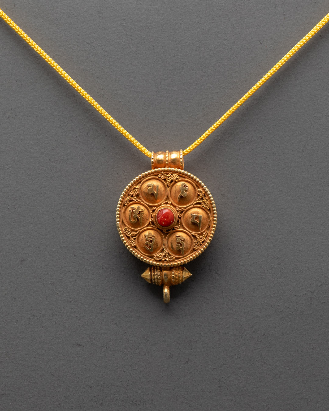 Front view of Tibetan Ghau Amulet Locket with coral and gold filigree for protection