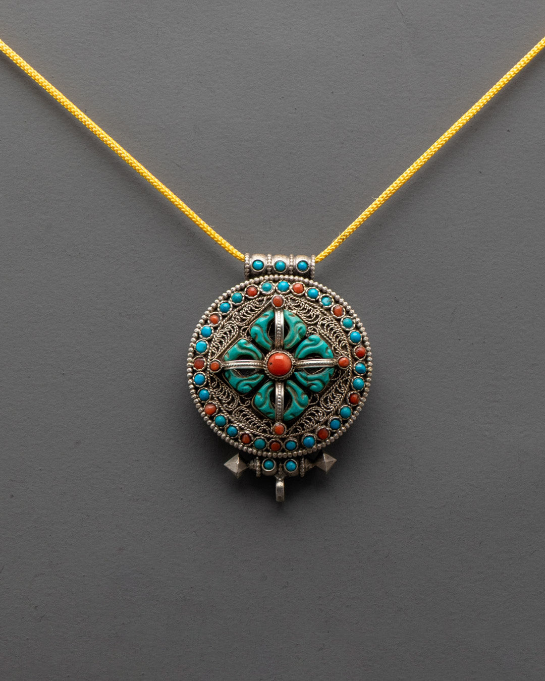 Close-up of intricate filigree design and semi-precious stones on Bishwo Vajra Locket