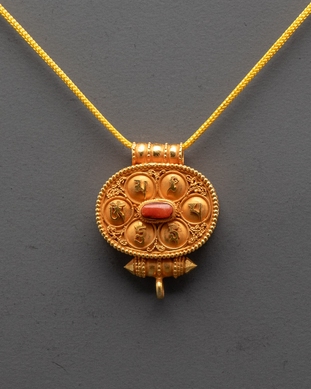 Close-up of coral-adorned gold-gilded Tibetan Prayer Box detail