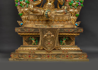 Lower landscape shot front of Green Tara Statue on lotus seat with Tibetan throne

