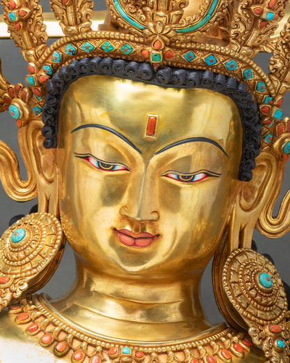 Maha Manjushri statue face detail with jeweled crown, ornate earrings, tilaka mark, and tranquil meditative expression